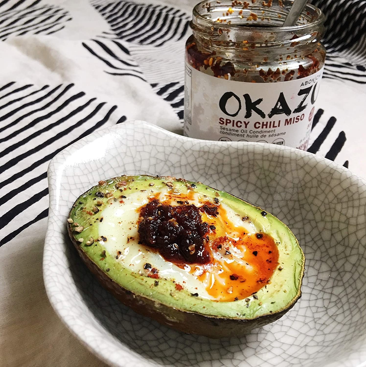 An avocado with chili miso suace on it