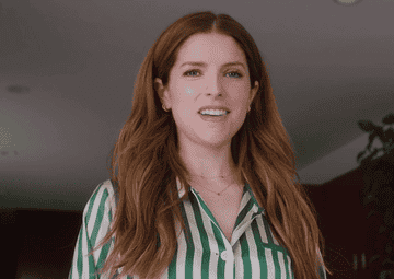 Anna Kendrick smiling and then rolling her eyes.
