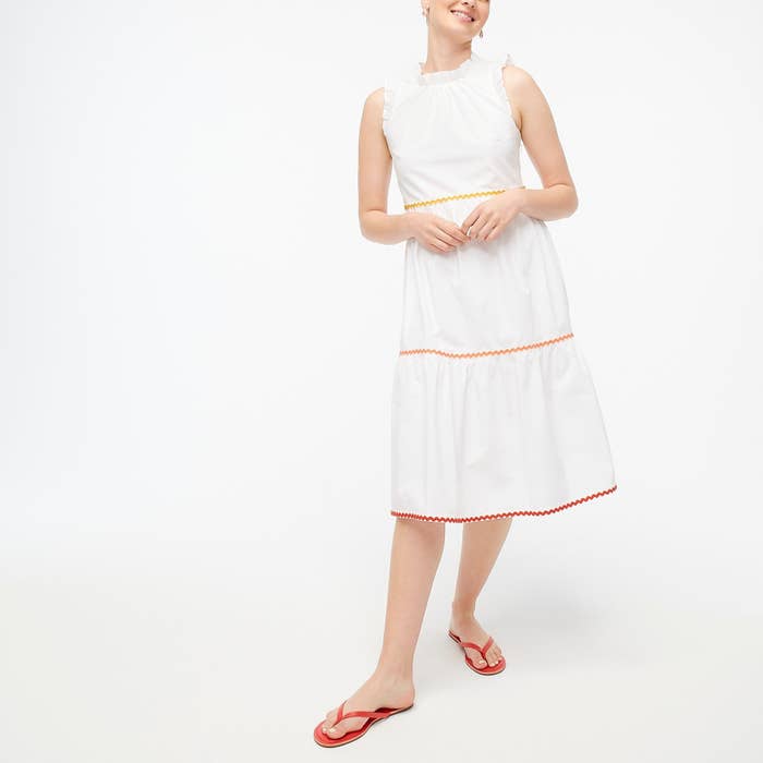 model wearing white dress with colored rickrack trim