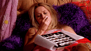 Reese Witherspoon eating chocolate in bed