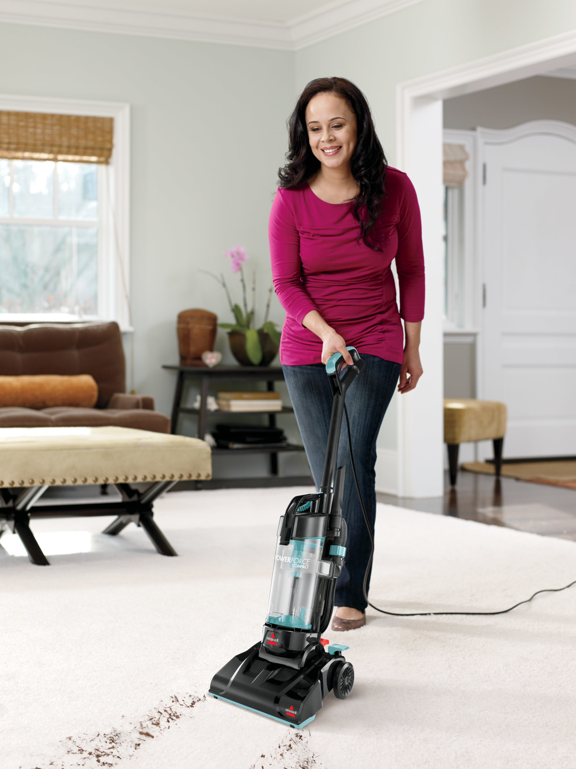 Person vacuuming a dirty rug