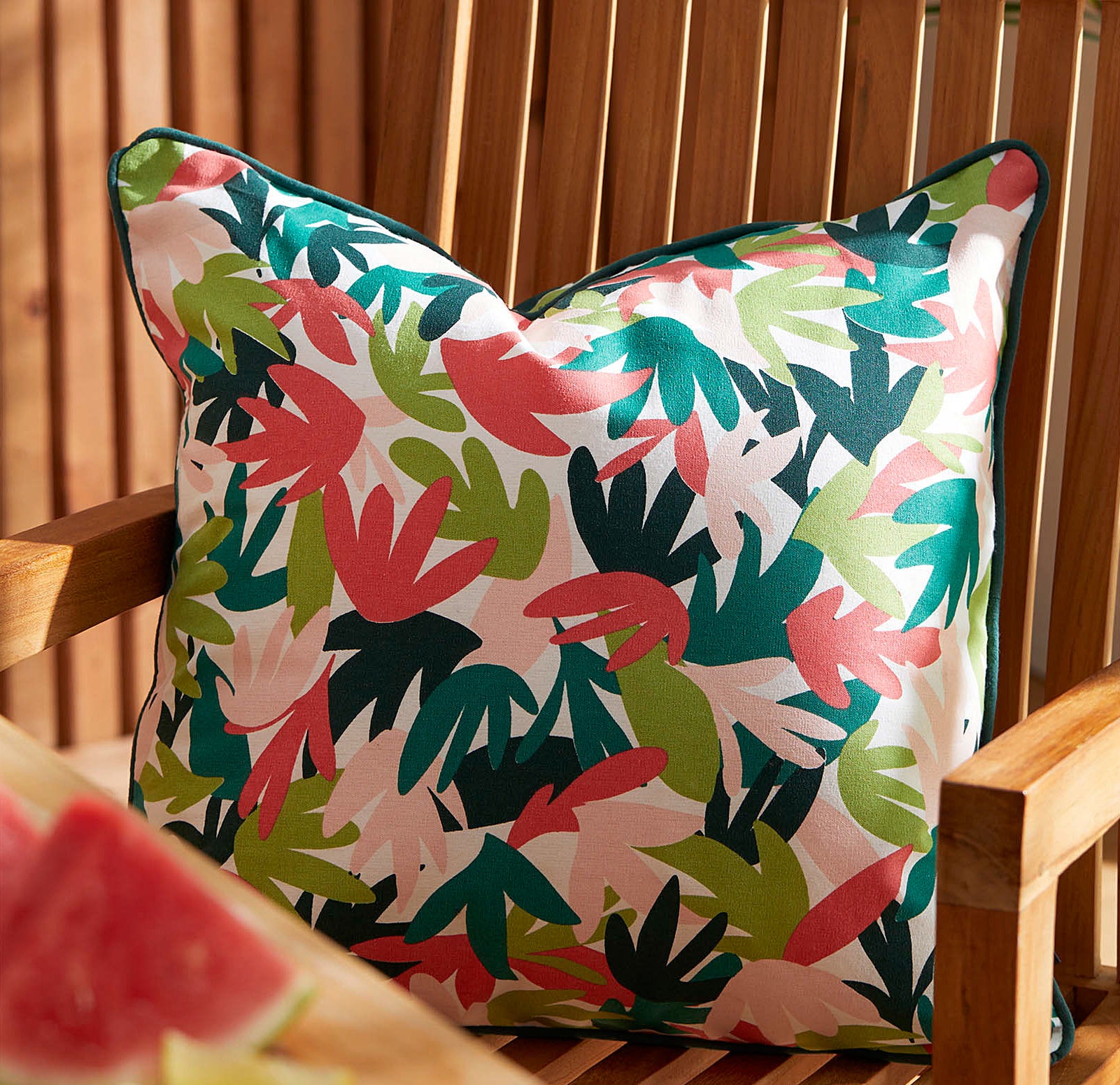 a vibrant patterned pillow on a chair