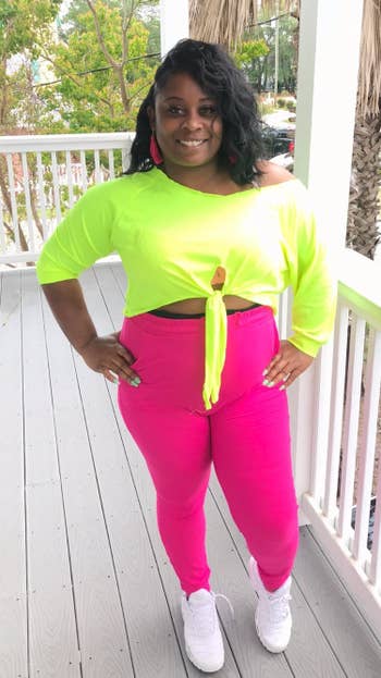 reviewer wears same joggers in a bright pink color with a neon yellow top