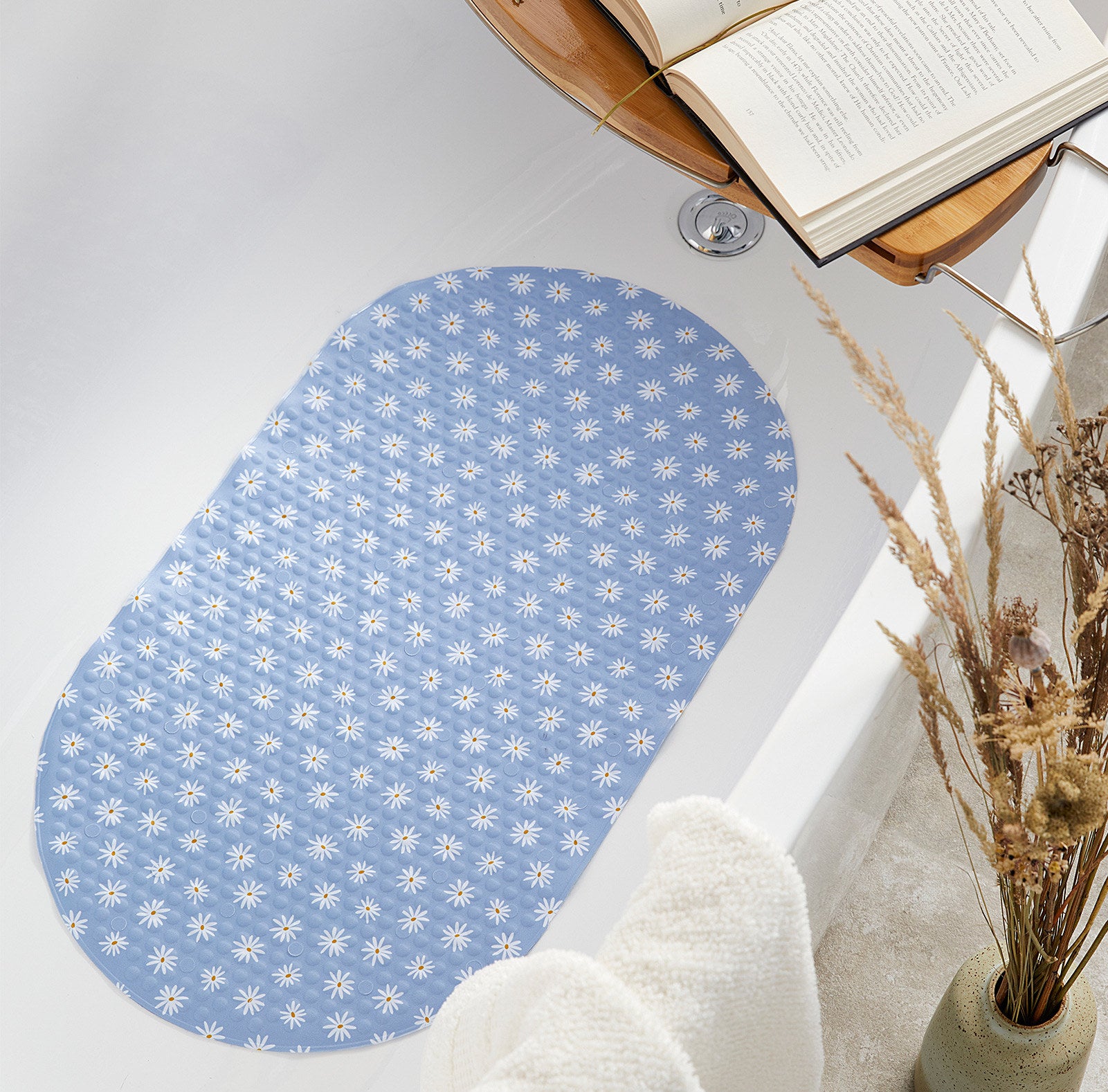 a floral bath mat in a tub