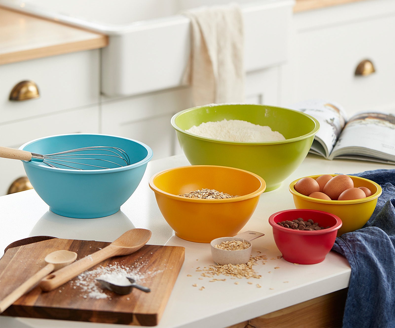five colourful bowls with various ingredients in them on a kitchen counter