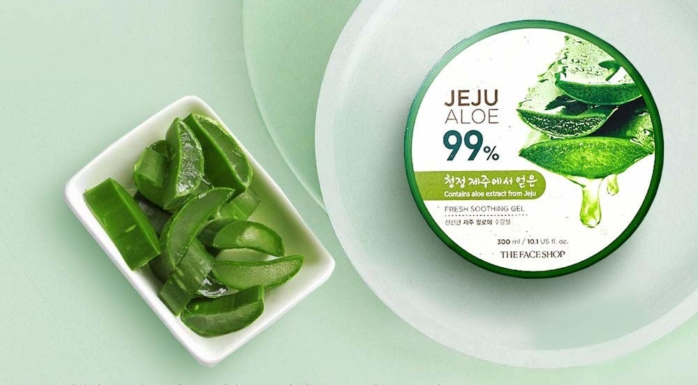 A tub of Jeju aloe gel from The Face Shop kept beside a bowl of fresh cut aloe vera.