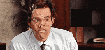 Jim Carey waving hello with his face taped in a comical way