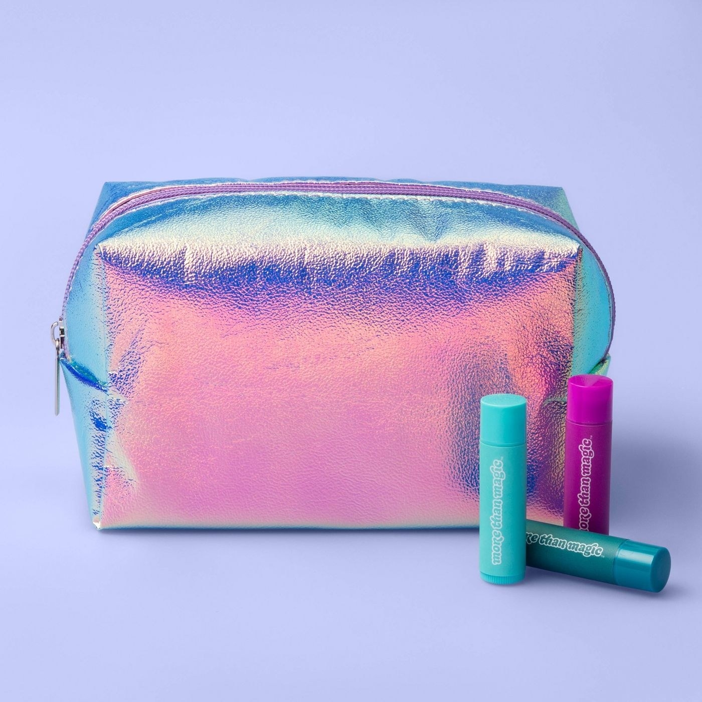A holographic makeup bag on a purple backdrop