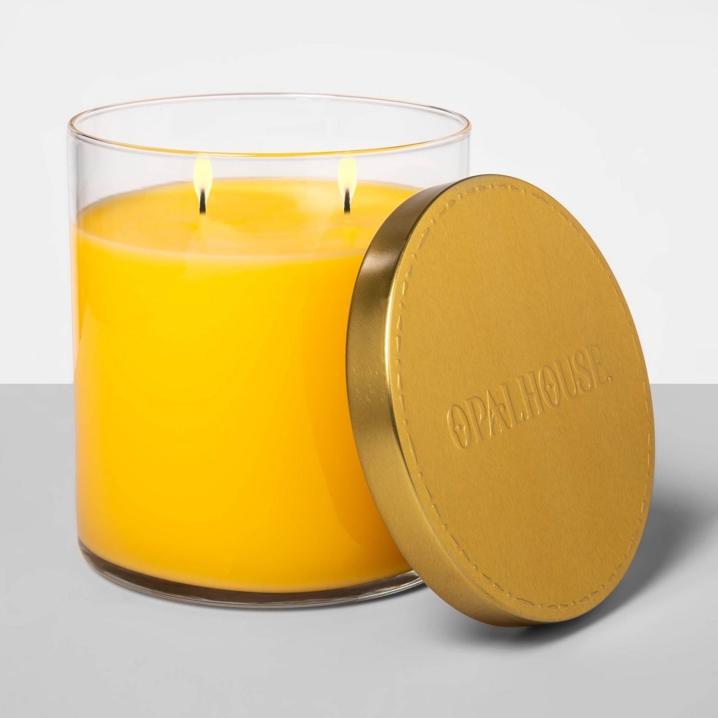 A yellow scented soy candle