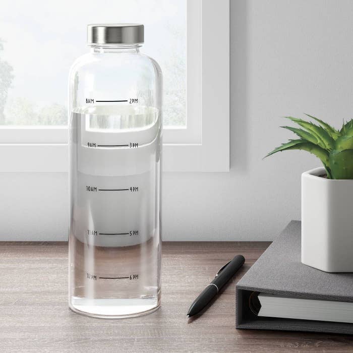 A hydration tracking water bottle on a desk