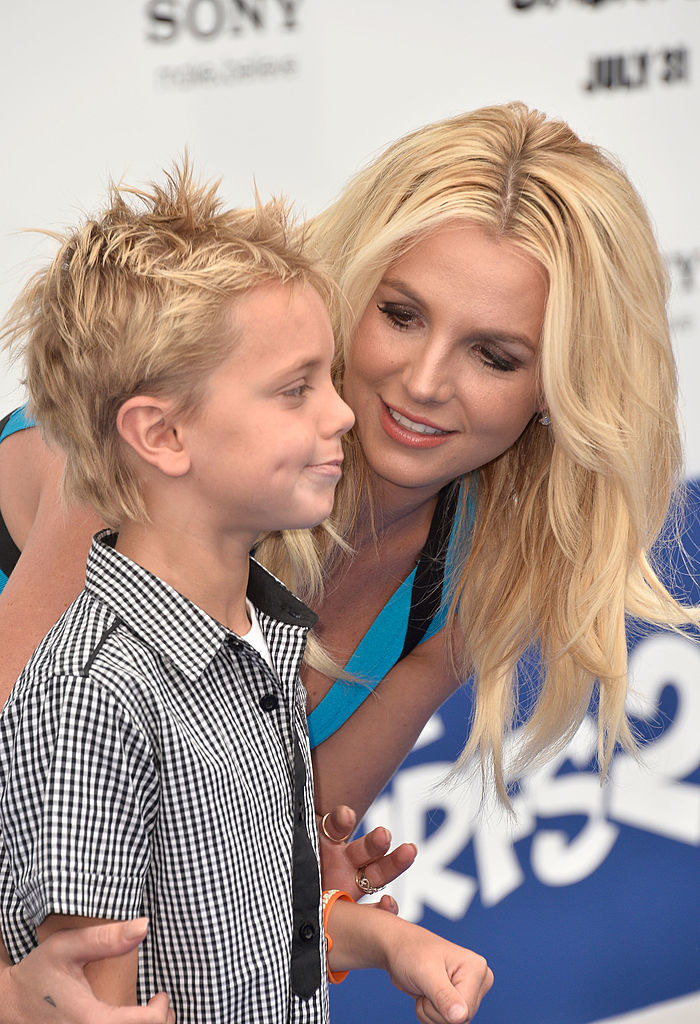 Britney kneeling down to hug one of her sons, Sean Preston Federline