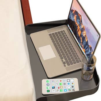 Bedside laptop table with laptop on top