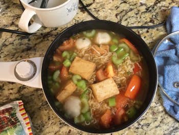Reviewer's hot pot with veggies and noodles inside