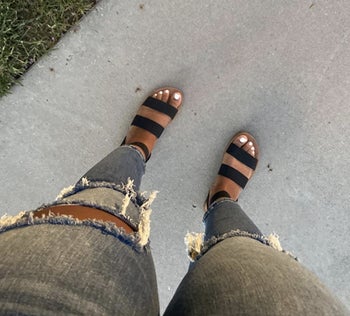 a reviewer wearing the sandals in black