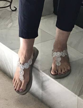 a reviewer wearing the sandals indoors
