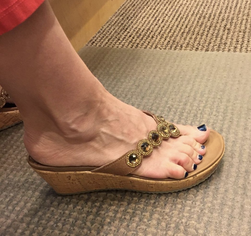 a person wearing the sandal in a tan color