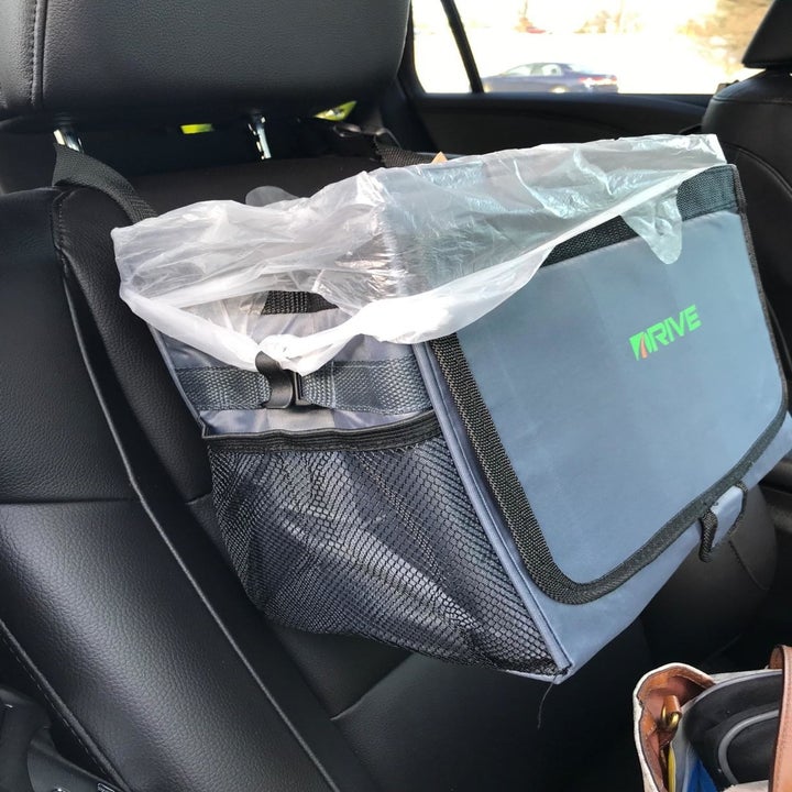 reviewer image of the Drive Bin hanging from the back of a car seat