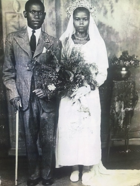 A wedding portrait of a man on the left and a woman on the right, both staring into the camera. 