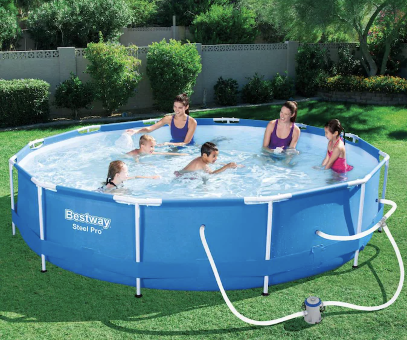 a family enjoying the above ground pool in a yard