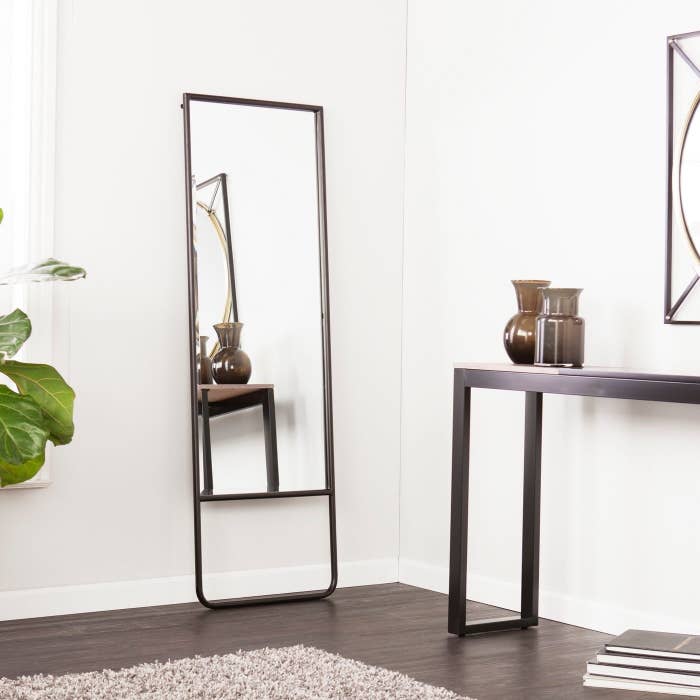 ¾ length leaning mirror with beveled edge and black frame