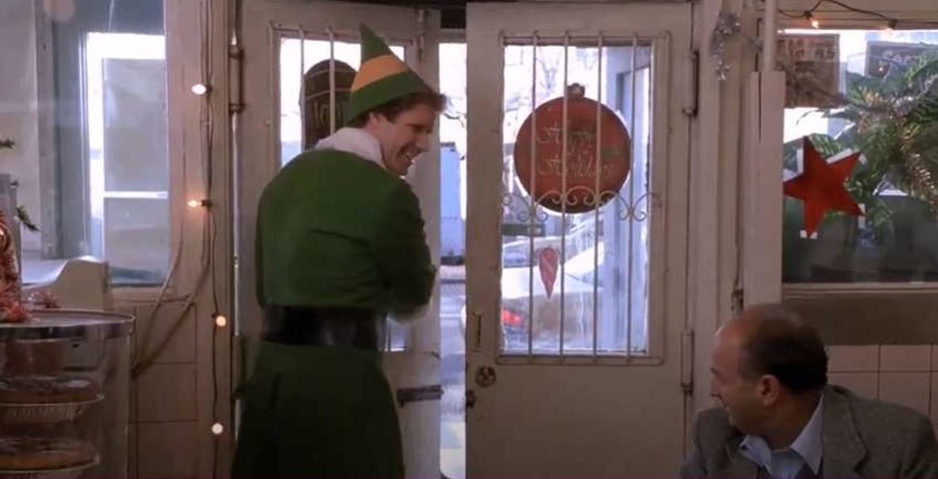 Man laughing while he looks at Buddy the Elf