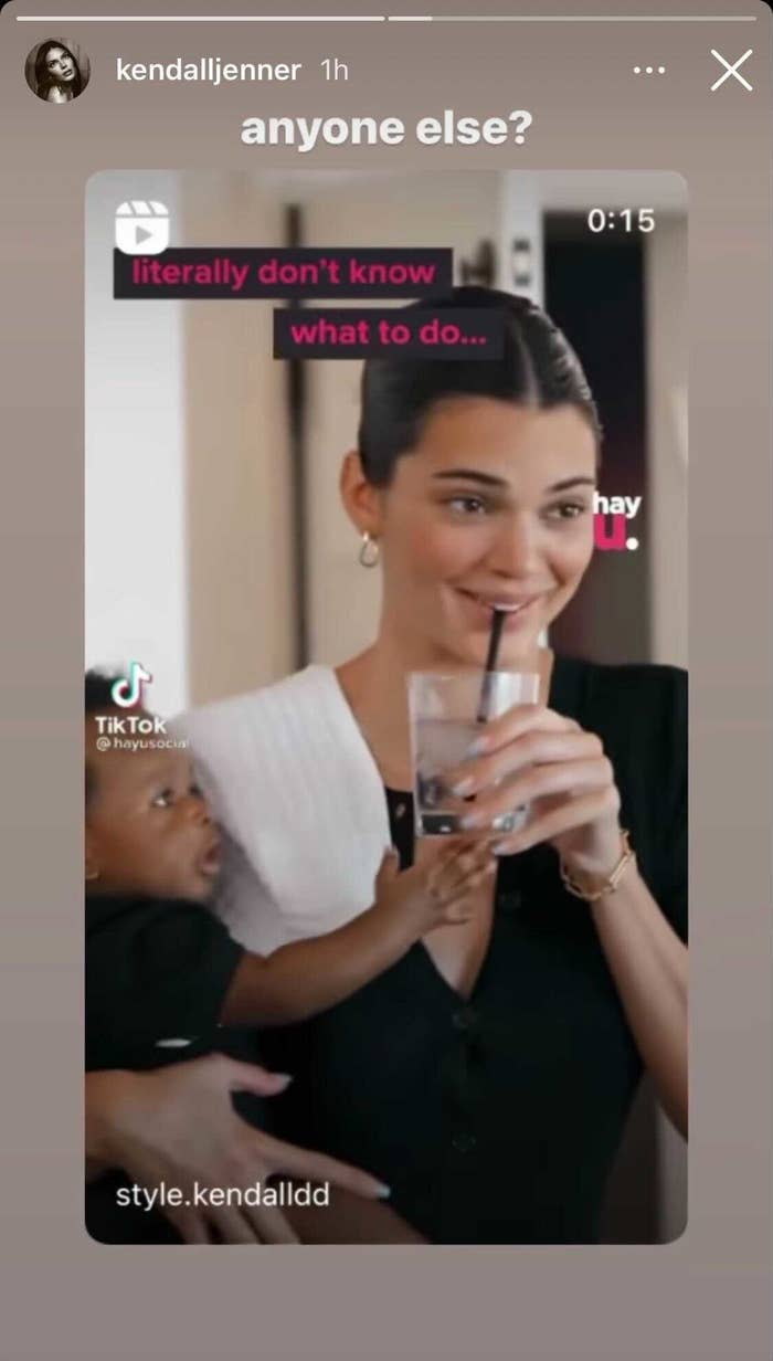 Kendall holding a glass and a baby who is reaching for it with the text &quot;Anyone else?&quot; from her IG story