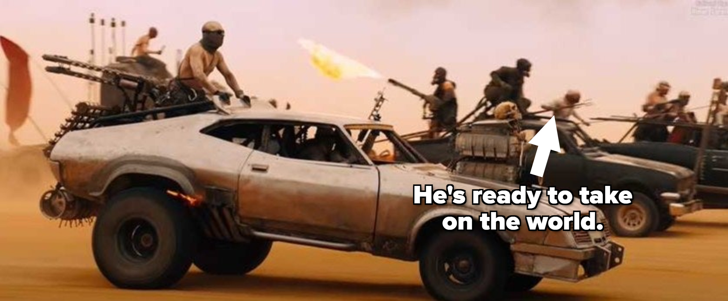 Man holding trident while hanging out of a fast-moving car in &quot;Mad Max: Fury Road&quot;