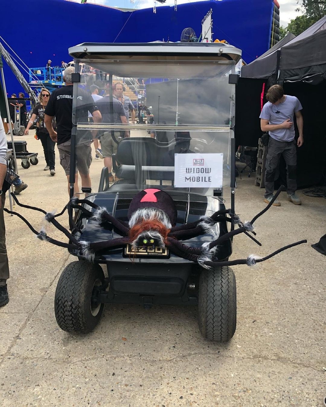 A golf cart with a giant spider on the front called &quot;Widow Mobile&quot;