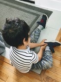 Boy wearing his shoes.