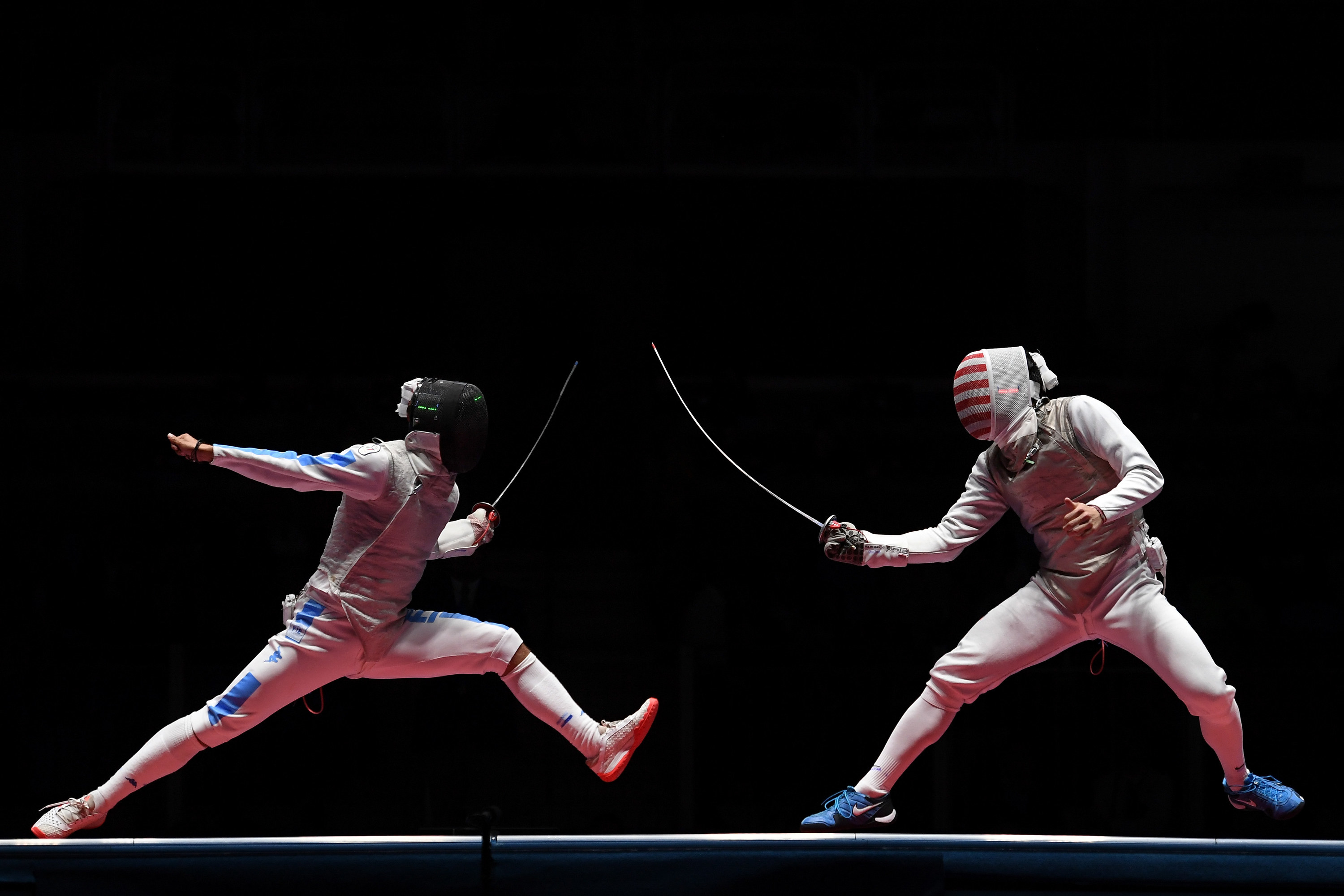 Two people fencing with thin swords