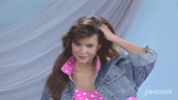 GIF of Kelly from &quot;Saved by the Bell&quot; twirling in a denim jacket and polka dot top