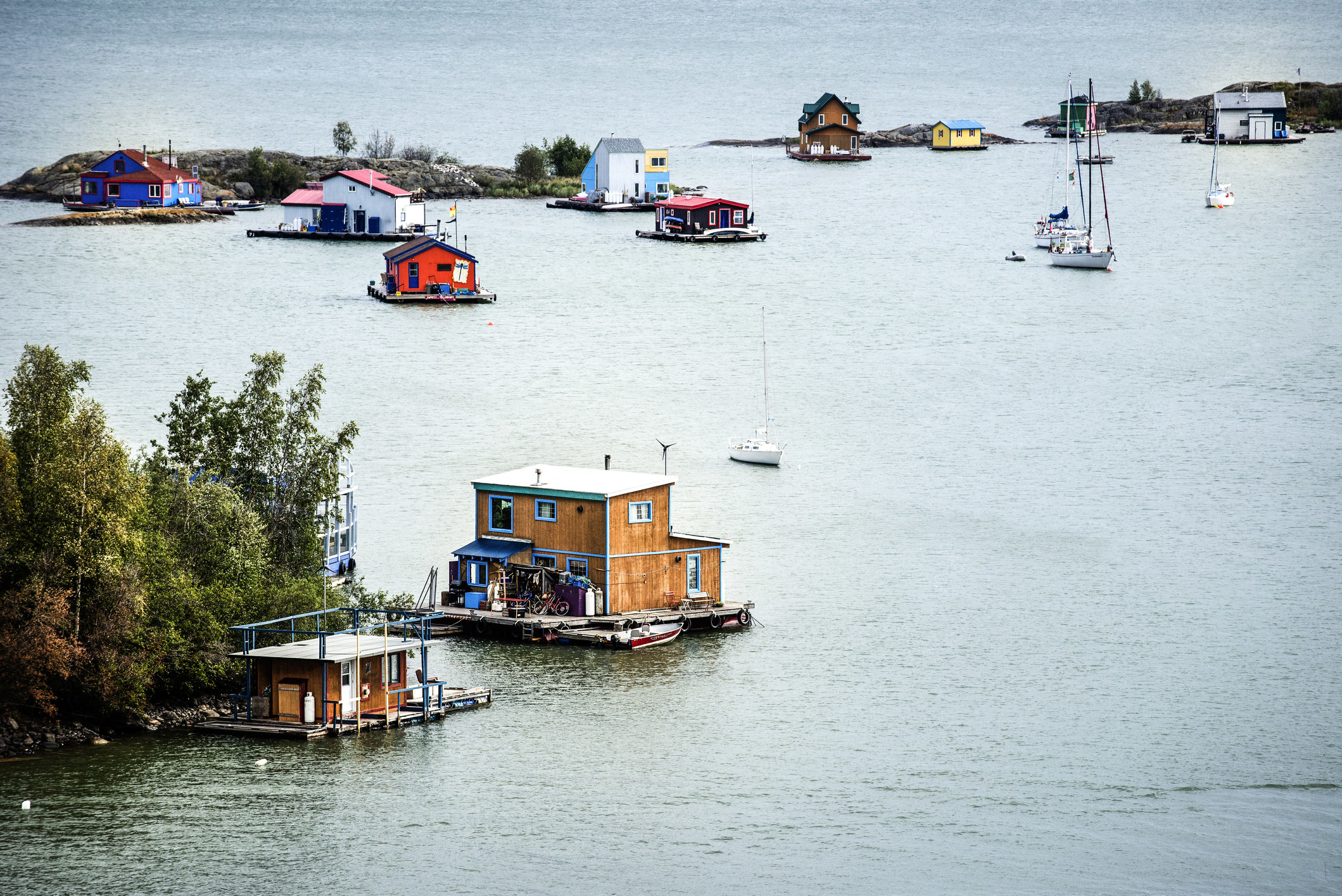 A colourful group of houseboats scattered in the bay of Great Slave Lake