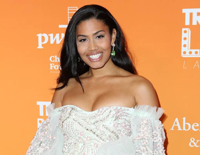 Leyna smiles in an off the shoulder mint dress with tiny embroidered flowers