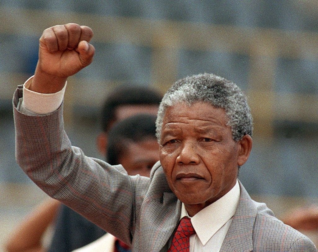 Nelson Mandela raising his fist in the air