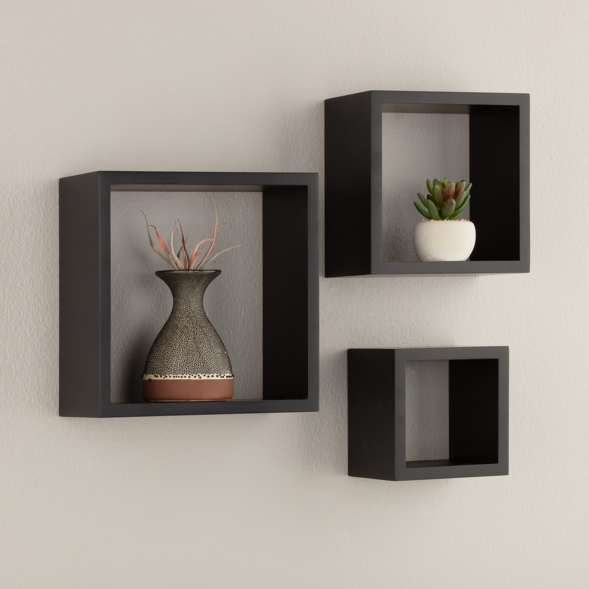 The three-piece set of nested floating black wall cubes