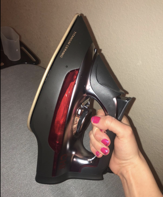 A reviewer holding the iron