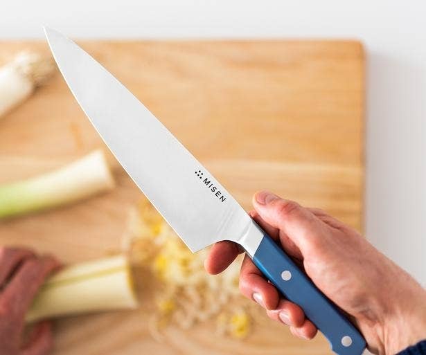 Model holding the knife with blue handle