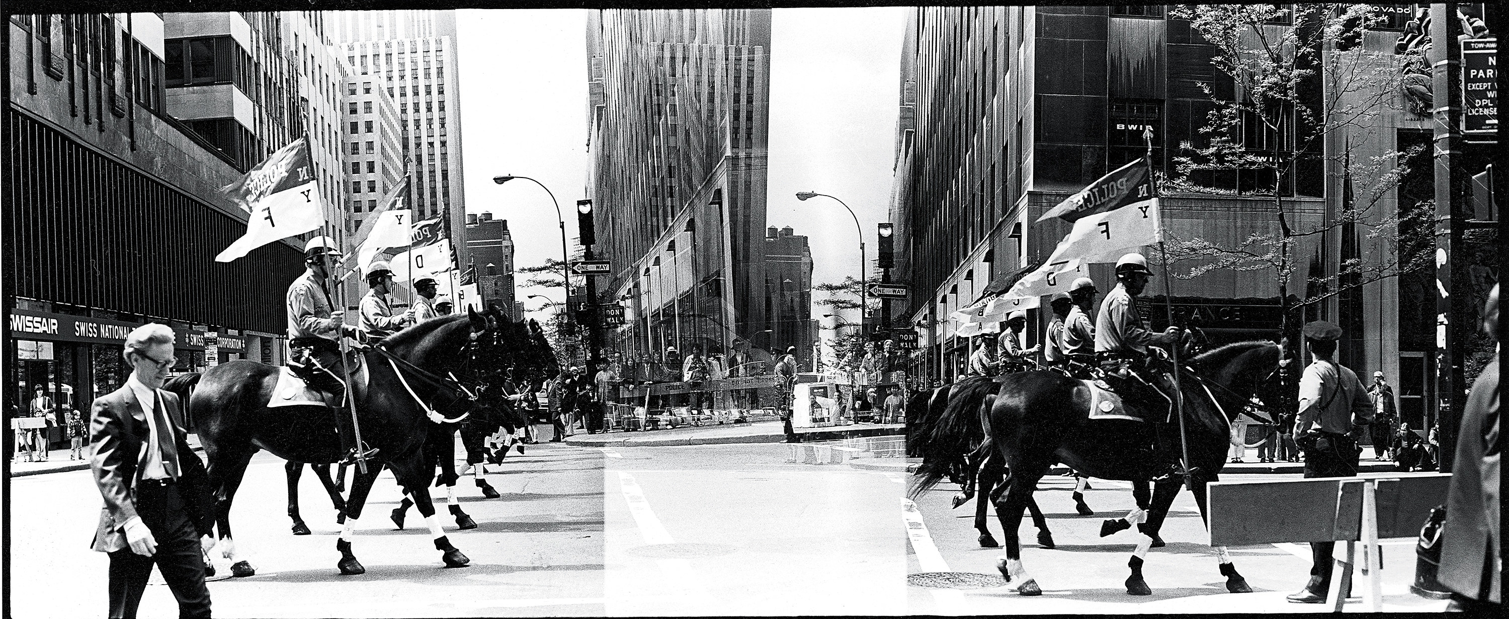 Mounted police walking down a street in New York