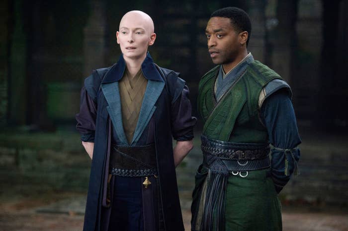Tilda and Chiwetel Ejiofor stand with their hands clasped behind them