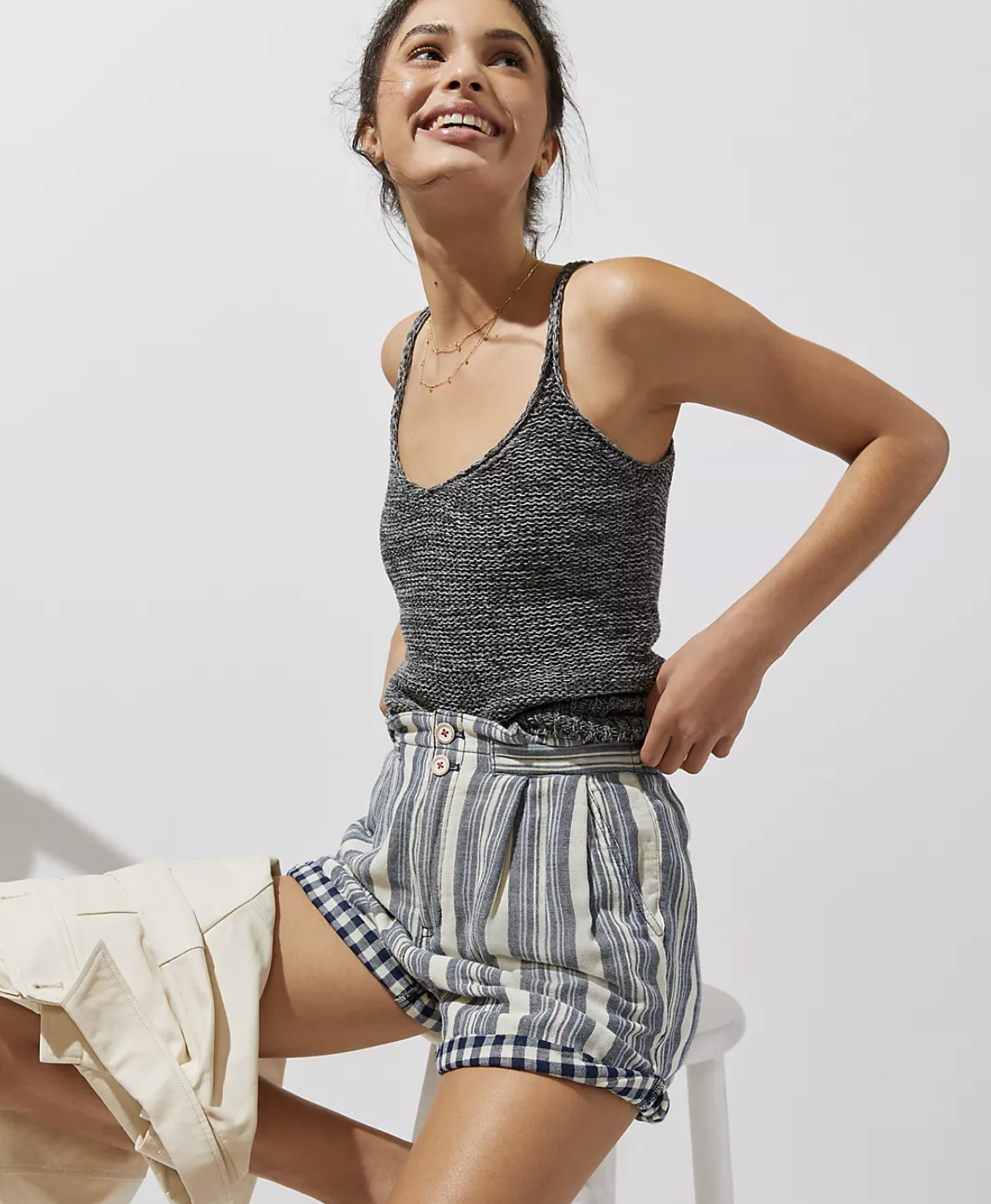 model in gray and white striped shorts rolled up to show gingham lining