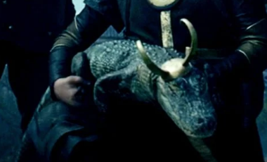 a crocodile with a loki hat on its head