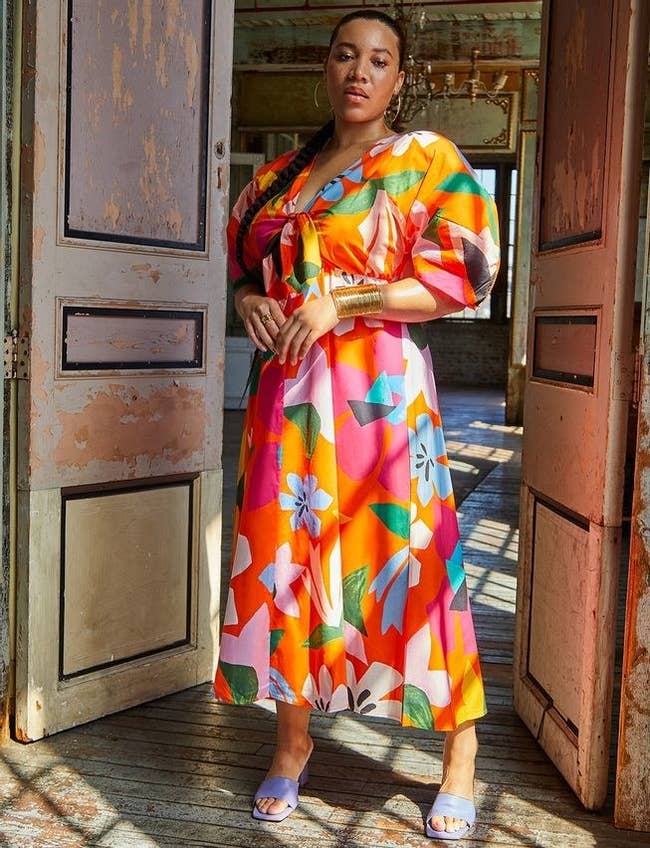 model wearing the bright multicolor dress with a tie-front and plunging neckline