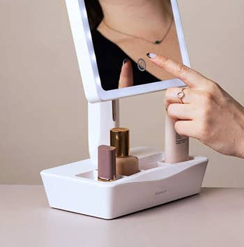 person using LED mirror