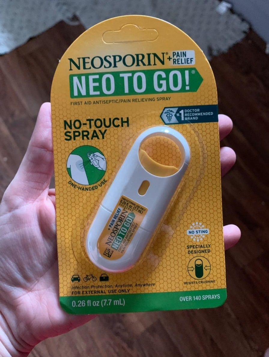 the Neosporin spray in its package being held by a reviewer