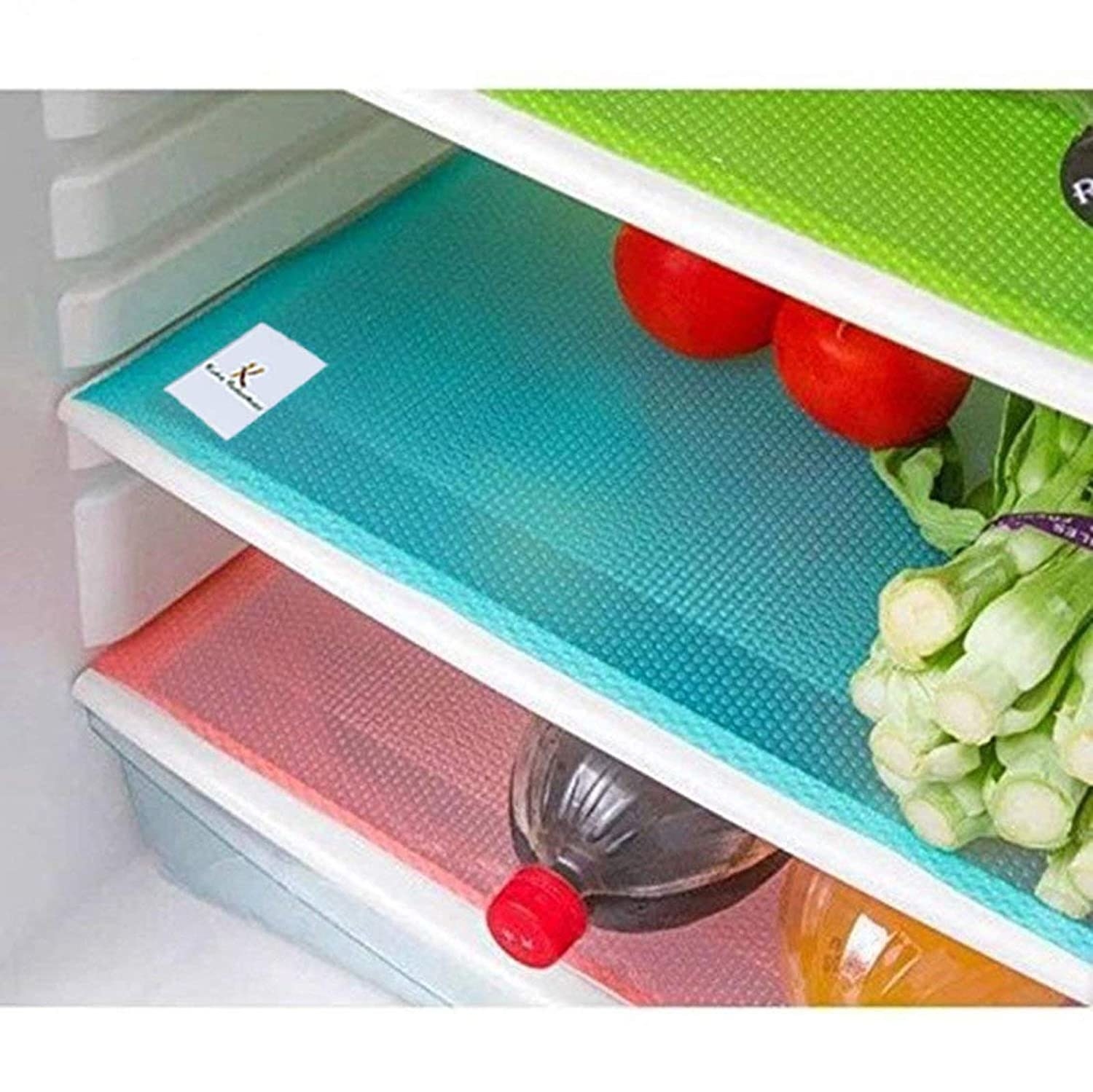 Red, blue and green mats in fridge with vegetables and beverages on top of them