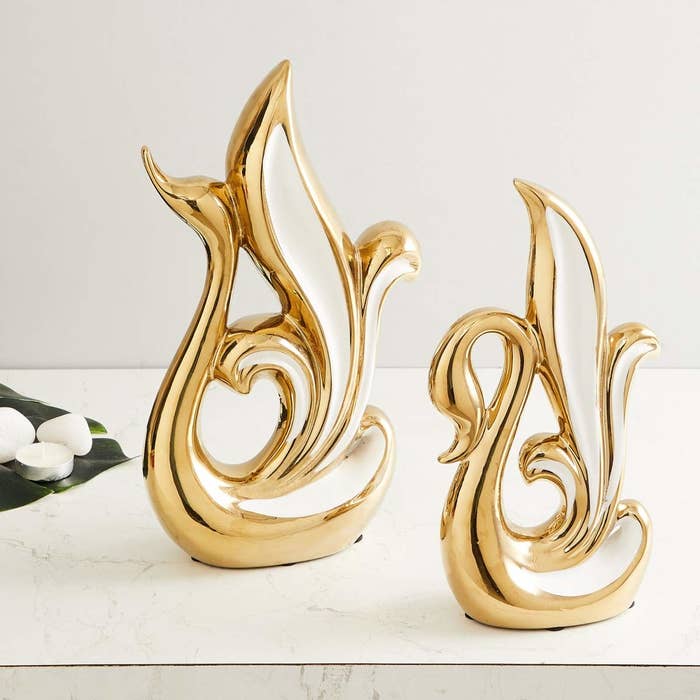 Two golden swans on a table