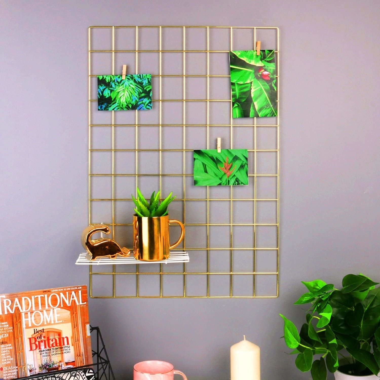 A golden grid with a golden mug-shaped planter and some photographs of plants on it