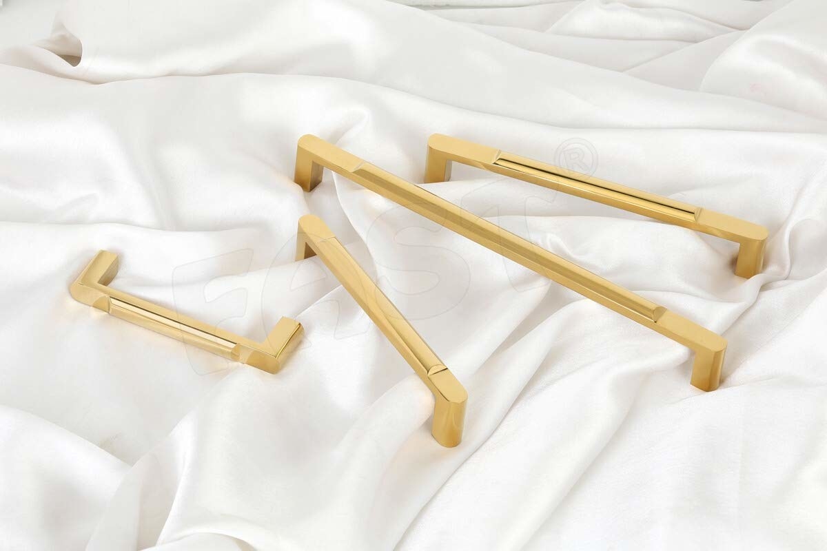 Golden door handles on a white bedsheet