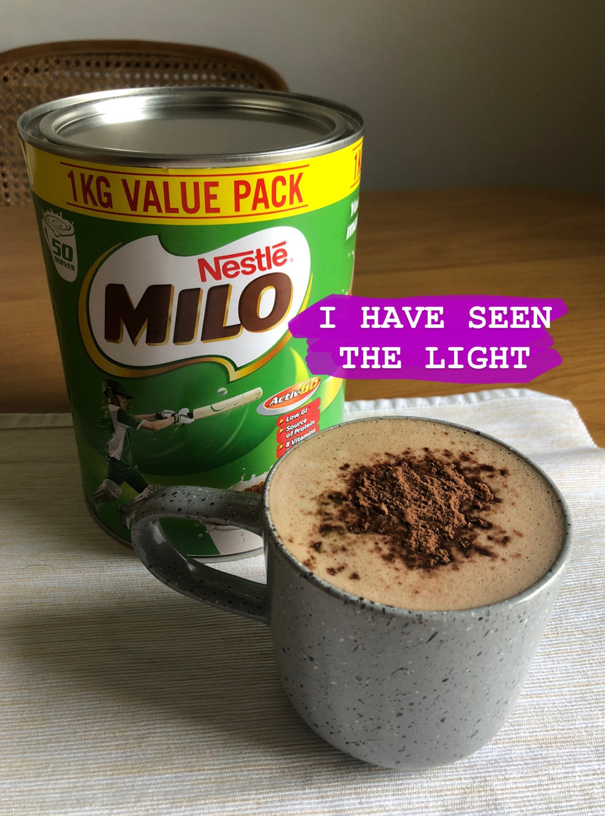 Can of Nestlé&#x27;s Milo next to a cup of Milo and Joe
