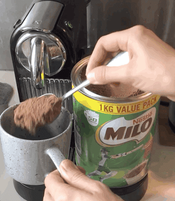 Person pouring Milo into a mug